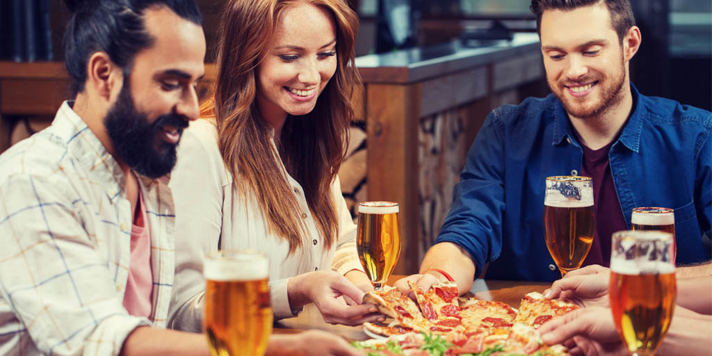 Group of friends eating pizza